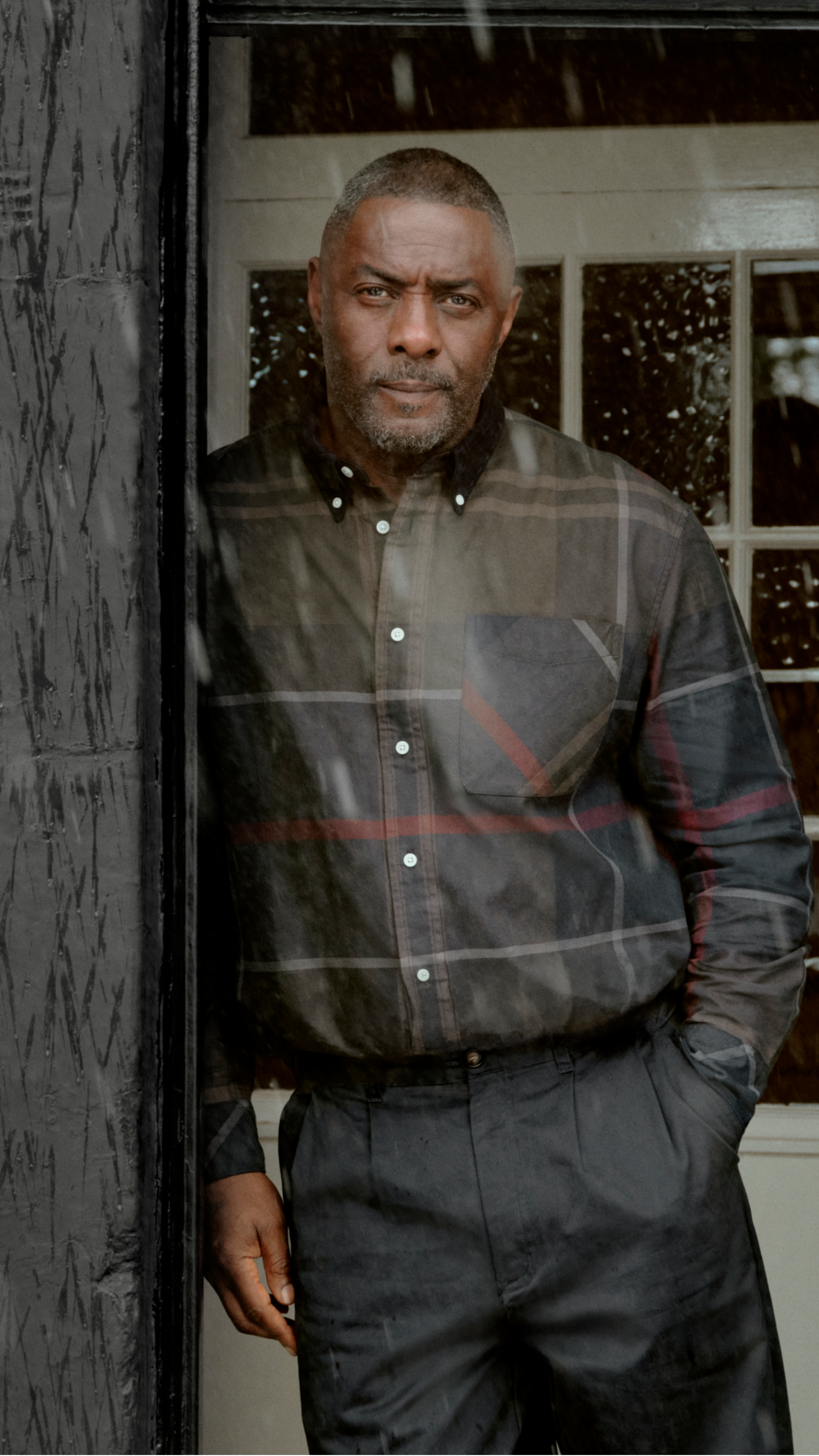 Sir Idris Elba in the Barbour Dunoon Tartan Shirt leaning against a wall